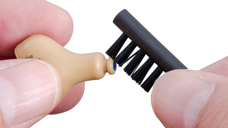 brush to remove cerumen